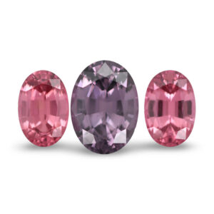 Three oval pink and mauve loose gemstones