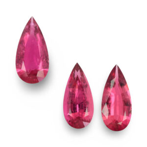 Three pear-shaped hot pink loose gemstones
