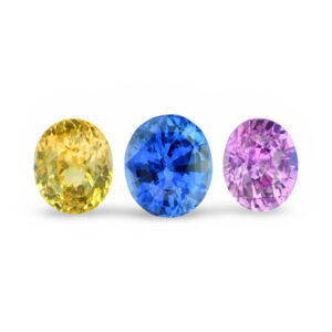 Three oval yellow, blue and purple loose gemstones