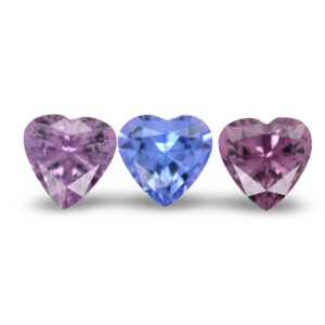 Three heart-shaped lavender and blue loose gemstones